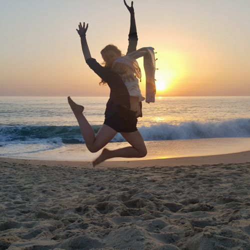 Kari jumping on the beach