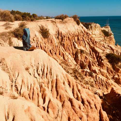 Growth Adventure, woman sitting next to sea